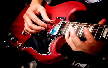 electric guitar close up with fingers playing it-1